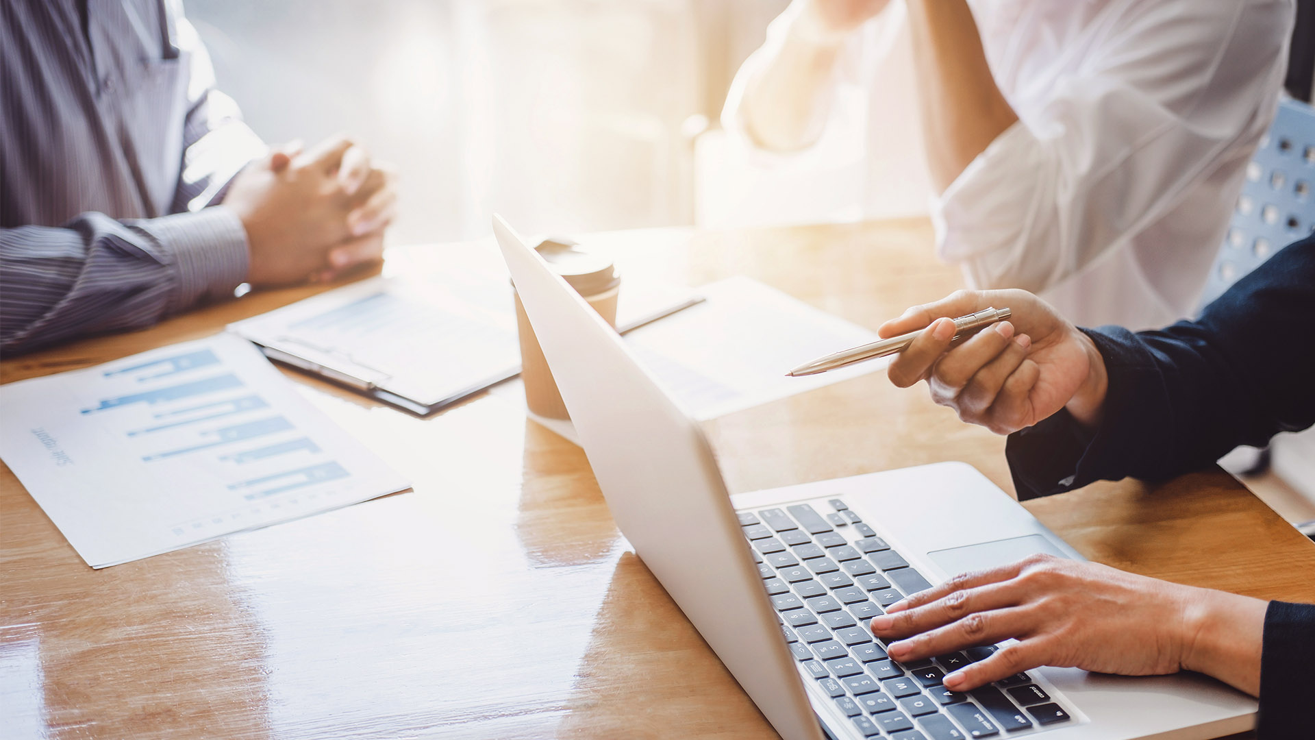 Header image of people working around laptop for the mahler team page